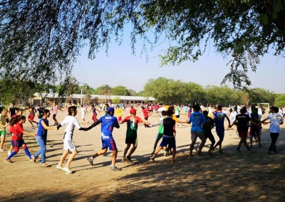 Young People Playing Together in the Ground