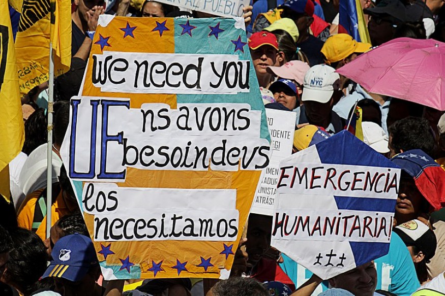 A crowd of people holding signs and banners.