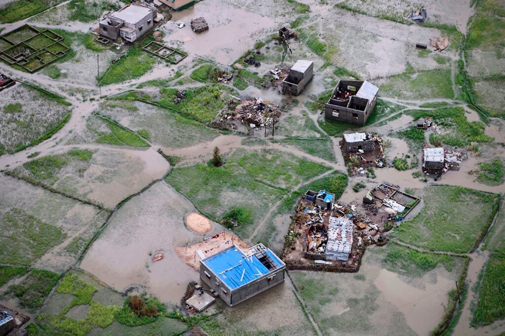 A view of some houses and buildings in the middle of a field.