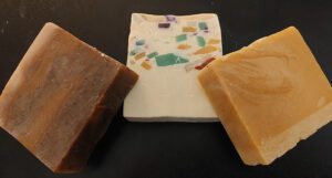 Three different types of soap sitting on top of a table.
