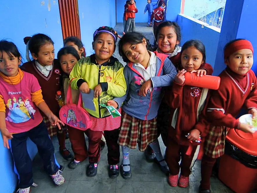 Group of smiling children in school uniforms.
