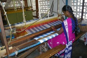 A person doing traditional weaving