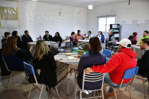 Group meeting around tables in a room.