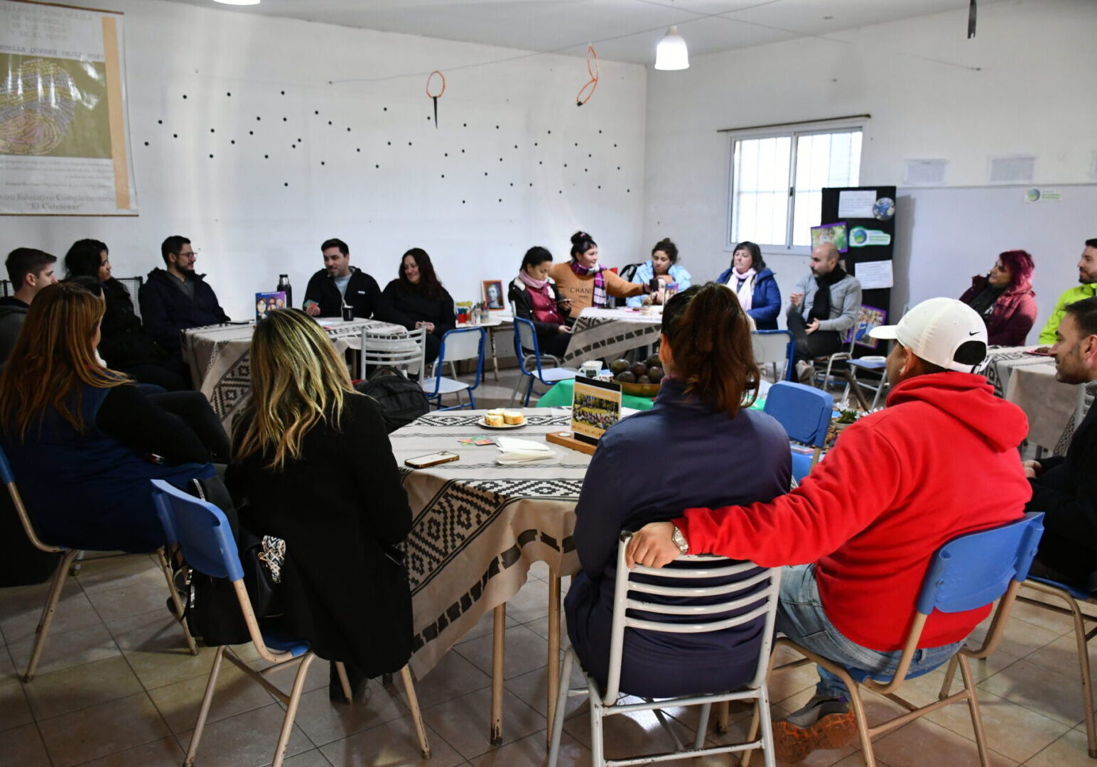 Group meeting around tables in a room.