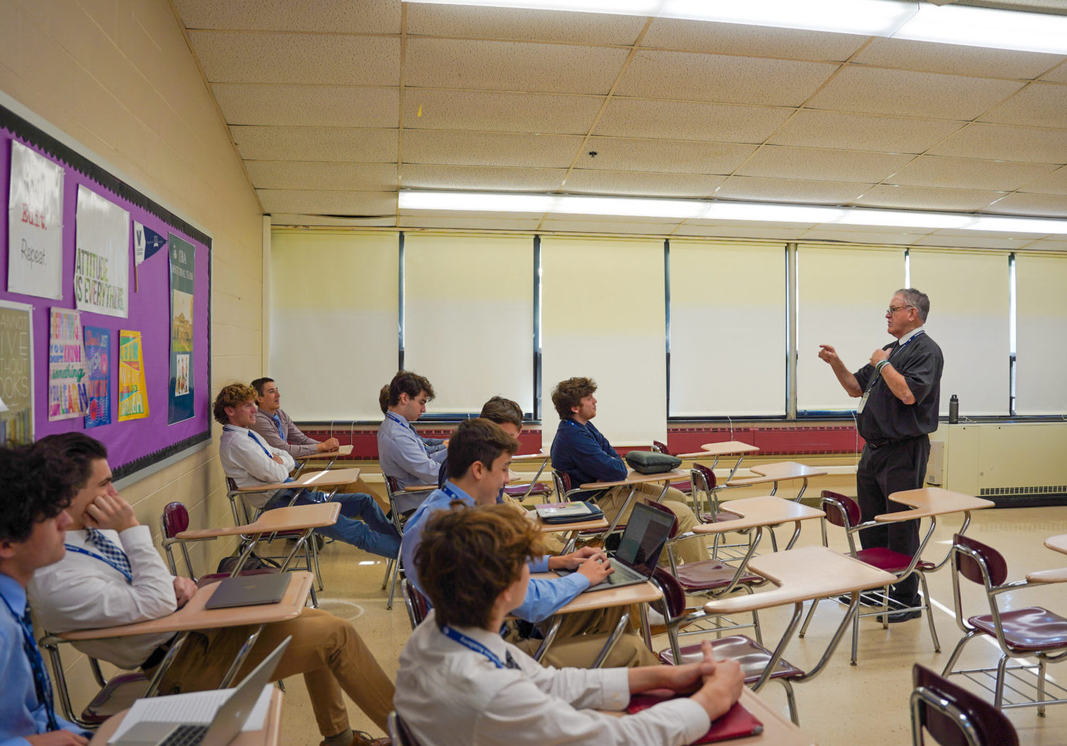 Teacher lecturing high school students in class.