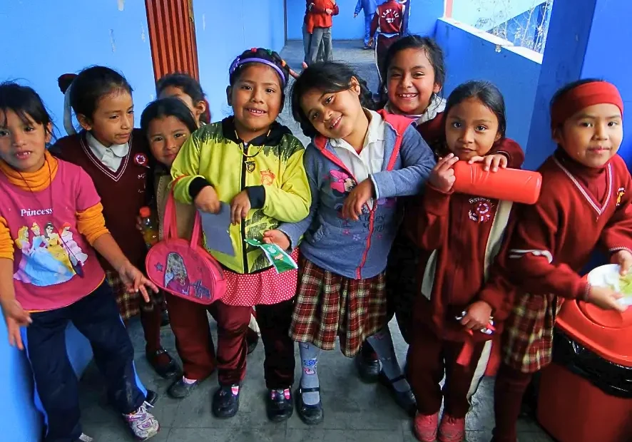 Group of smiling children in school uniforms.